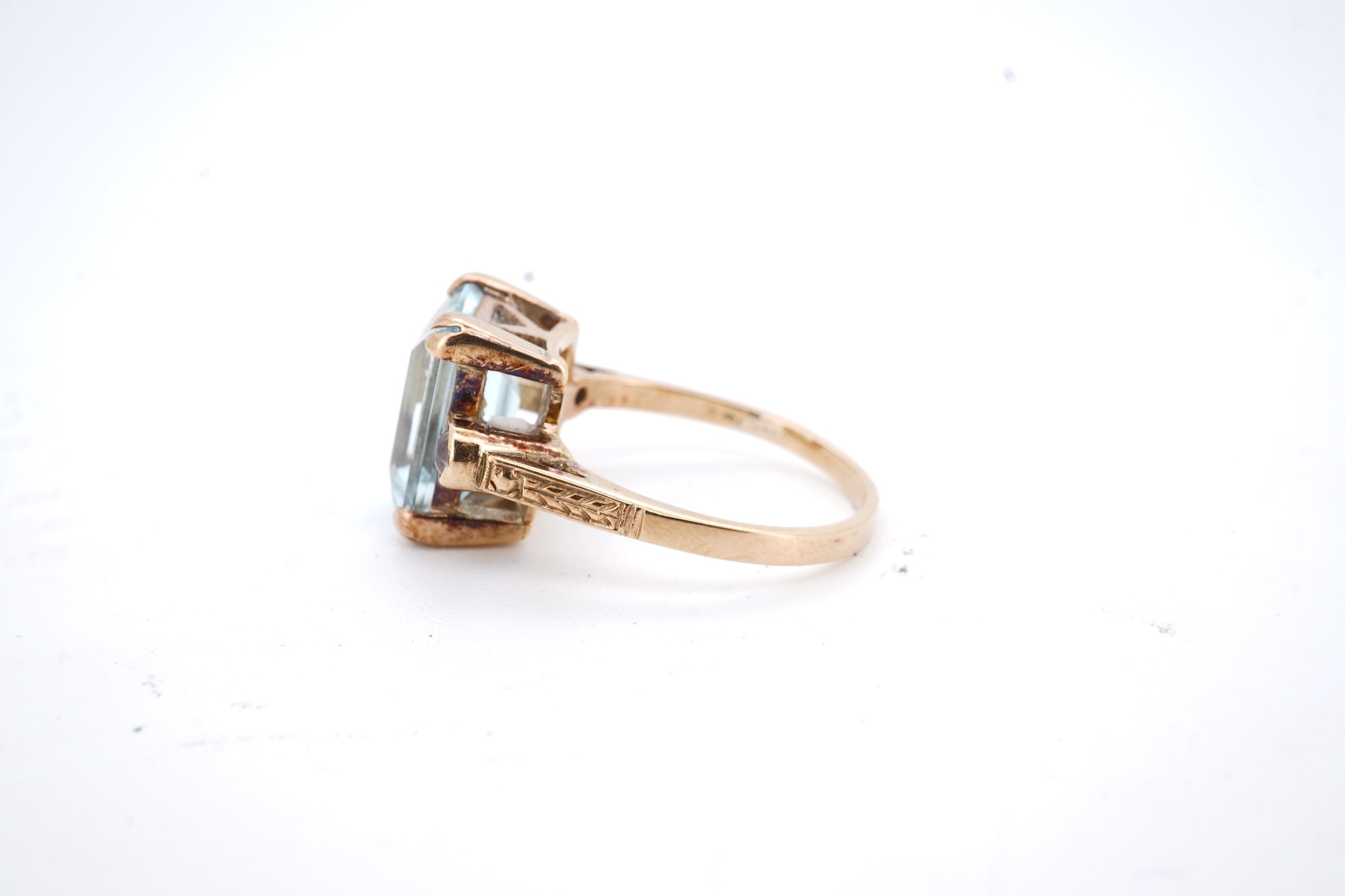 A yellow metal and single stone emerald cut aquamarine set ring, with two stone diamond set shoulders, size M, gross weight 4.2 grams.